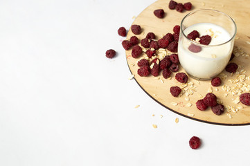 healthy snack with homemade yogurt, oat flakes and raspberry in the glass. Horizontal