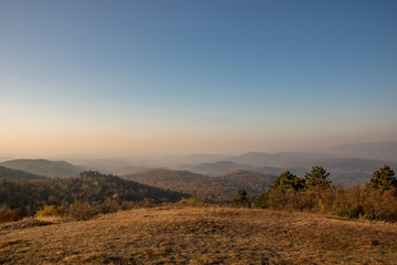 Hills of Nagy-Séznás, a Hungarian mountain just before sunset, with lots of yellow grass everywhere,