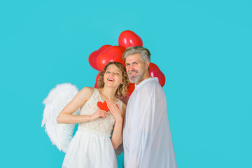 Lovely Valentines day couple. Cupid angel with paper heart. Cupid in valentine day. Couple of...