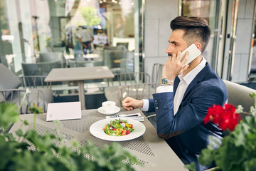 Busy brunette man being in cafe alone
