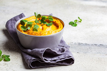 Sweet potato hummus or pumpkin dip in a gray bowl.