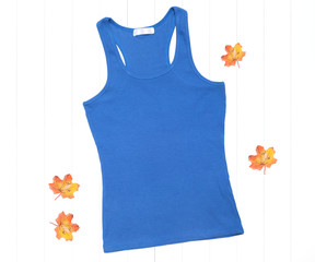 Blue tank top and bright autumn leaves on a white background