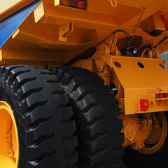 body and wheels of a huge mining dump truck close up © Sergey