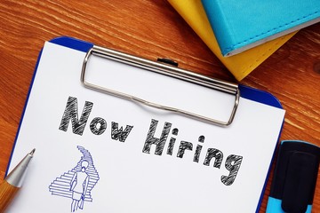 Financial concept meaning Now hiring with sign on the page.