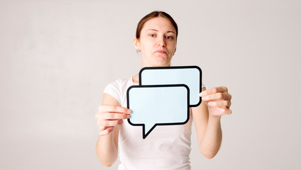 Woman shows sign speech bubbles. Speech bubble banner. Happy girl hold empty speech bubbles.