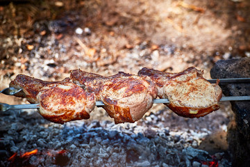 Cooking juicy meat on the grill in the afternoon.