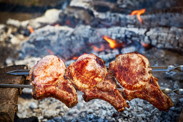 Cooking juicy meat on the grill in the afternoon.