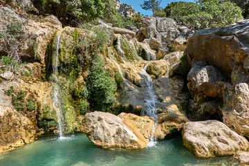 Naklejka na ściany i meble Waterfalls of the Guadalquivir river as it passes through the Utrero enclosure in the Sierra de Cazorla, Segura and Las Villas Natural Park. Jaen. Andalusia. Spain