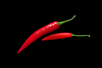 Red chili peppers on a completely black background