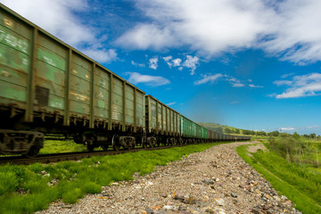 Obraz premium Freight train with old rusty wagons in motion