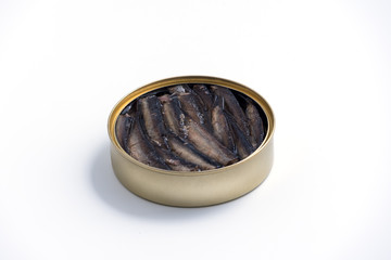 Smoked sprats in cooking oil in the open tin can isolated on white background