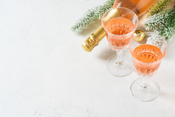 Bottle of rose sparkling wine or champagne with wineglass
