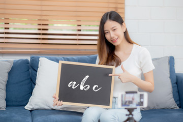 Young asian woman is teacher teaching language english with student for e-learning online at home,...