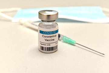 Coronavirus COVID-19 vaccine vial, container, bottle and syringe at Pfizer laboratory