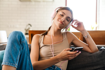 Relaxed woman listening to music with headphones