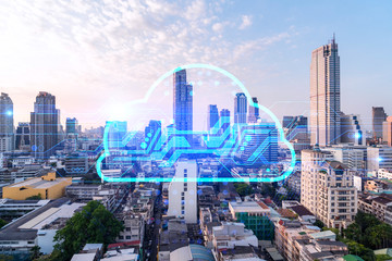Glowing hologram of cloud icon, aerial panoramic cityscape of Bangkok at sunset. The concept of secure storage of digital data in Asia. Multi exposure.