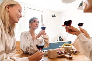 Beautiful cheerful girlfriends in kitchen