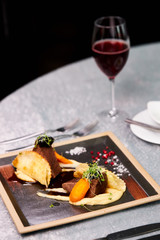 beautifully decorated steak on plate in restaurant, tasty restaurant food. cuisine, restaurant, food concept