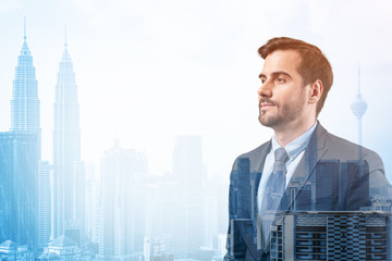 Fototapeta premium Young handsome businessman in suit thinking how to succeed, new career opportunities, MBA. Kuala Lumpur on background. Double exposure.