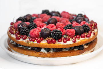 beautiful cake with fresh berries on a white background close up