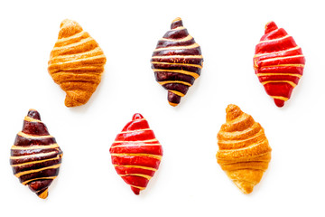 Set of croissants - chocolate, berry, classic - on white background top view
