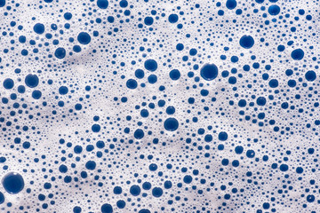soap foam on a blue background - macro photography