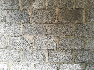 A Wall made of cement blocks and concrete like texture.