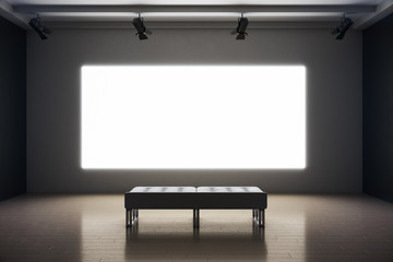 Modern exhibition room with blank projection screen and bench