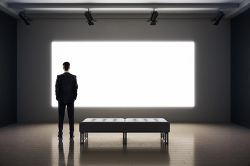 Businessman standing in exhibition interior
