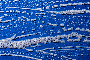 soap foam on a blue background - macro photography