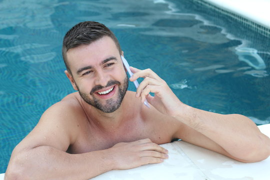 Man using cellphone in swimming pool 
