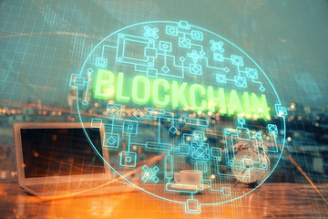 Multi exposure of blockchain theme hologram and table with computer background. Concept of bitcoin...