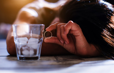 Young beautiful woman in depression, is drinking alcohol.