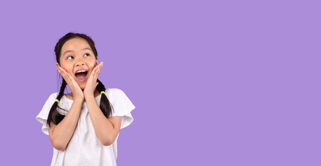Excited Asian Girl Touching Face Posing Standing On Purple Background