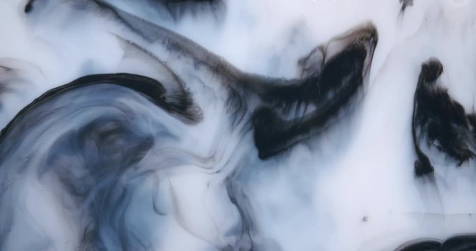 Top down shot of a viscous liquid creating wonderful shapes and patterns. Liquid moving forward and backwards.