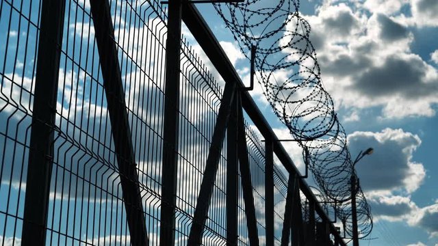 Prison fence with barbed wire