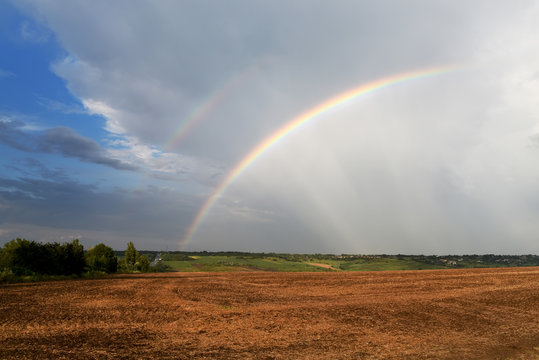 Double rainbow over fields and road. © Ann Stryzhekin