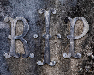 Rest in Peace abbreviation, RIP, on a headstone.