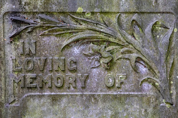 In Loving Memory of - written on a headstone in a graveyard.