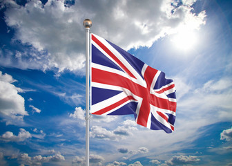 Realistic flag. 3D illustration. Colored waving flag of United Kingdom on sunny blue sky background.
