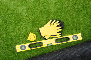Tools on the artificial grass background. Top view. - obrazy, fototapety, plakaty