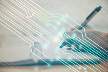 Double exposure of writing hands on background with data solution hologram on front. Technology concept. Close up