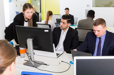 Business people working and communicating together in modern open plan office