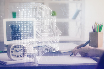 Multi exposure of writing hand on background with brain hologram. Concept of learning.