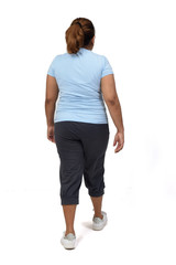 rear view of a woman with sportswear walking on white background,