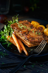 grilled ribs with potatoes and vegetables