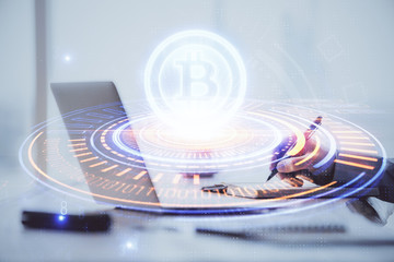 Blockchain theme hologram with man working on computer on background. Concept of crypto chain. Double exposure.