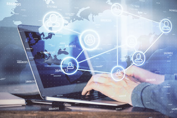 Social network theme hologram with businessman working on computer on background. Concept of world wide web. Multi exposure.