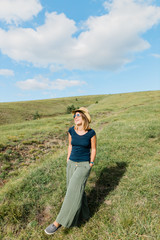 Young woman enjoying on the hillside meadows