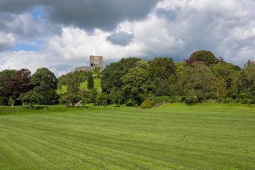 Fototapeta na wymiar View of Clitheroe castle and trees with a blue sky background. Ribble valley public park
